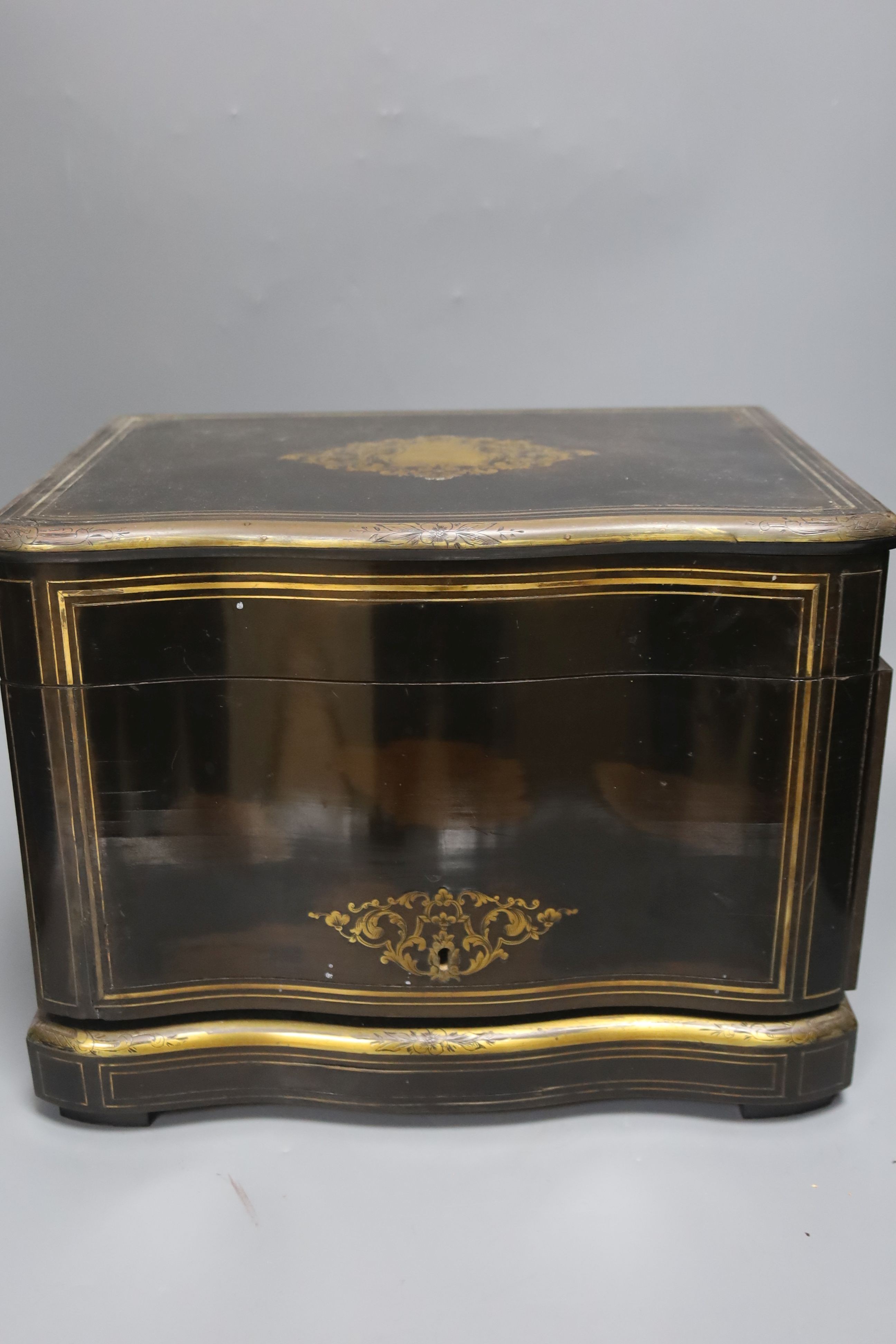 A mid-19th century French ebonised and brass-inlaid decanter case, fitted four decanters and seven glasses on removable tray (incomplete), W 35cm